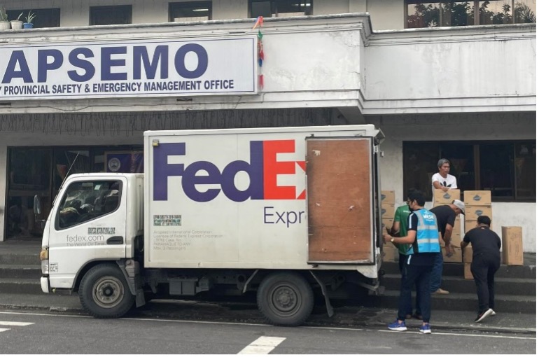 Unloading of donations from FedEx truck to Albay Provincial Public Safety and Emergency Management Office (APSEMO)