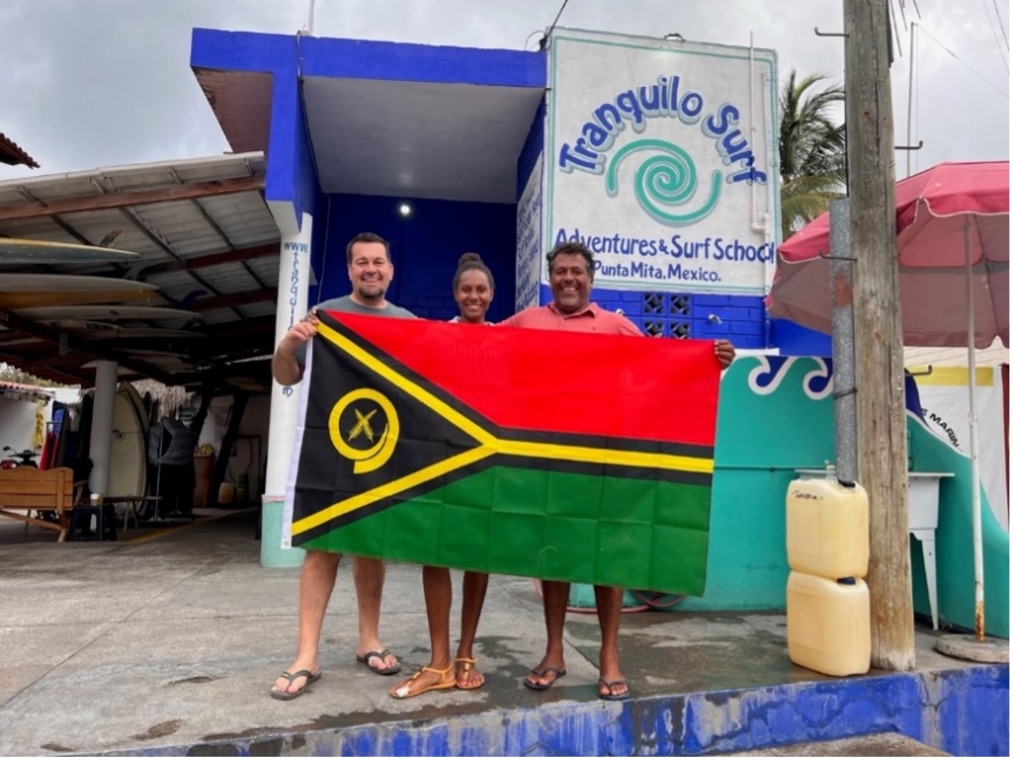 Glen loves traveling and goes nowhere without a flag of Vanuatu. Here, with his partner Stephanie and Josue from the famous Tranquilo Surf Co. in Mexico. Photo: Glen Craig
