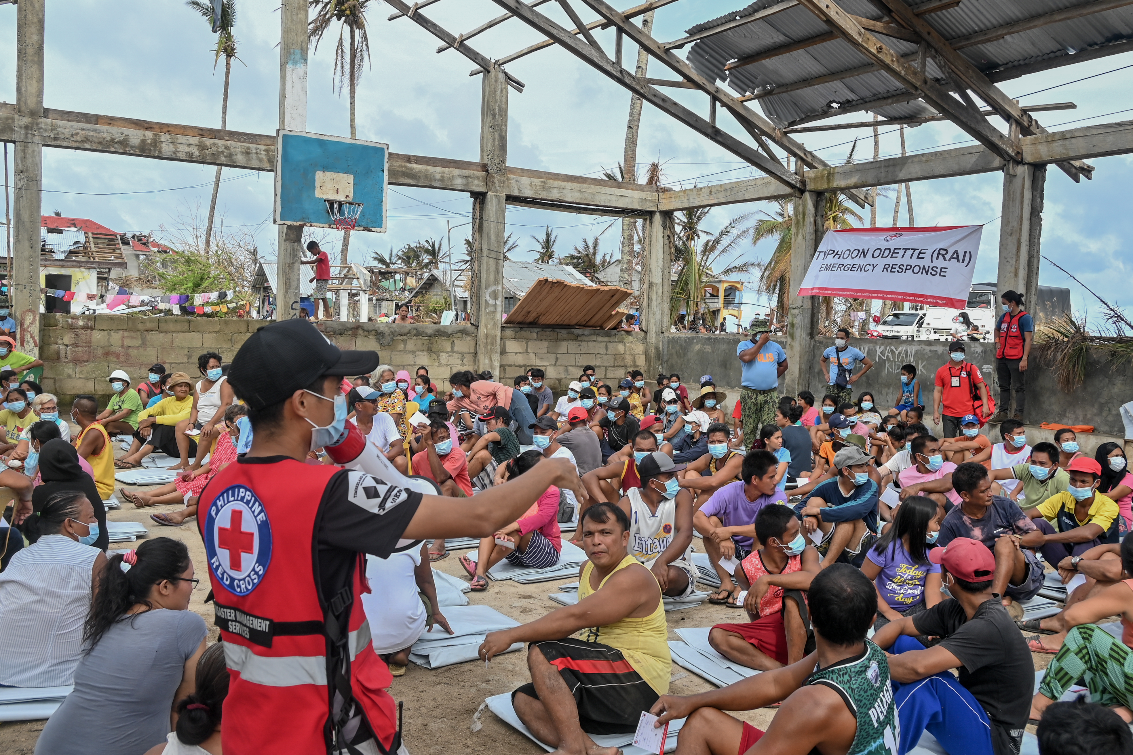 Red Cross volunteer talking to displaced families in the Philippines