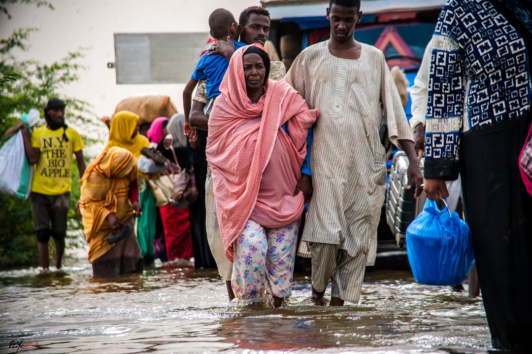 People escape floods in Sudan, with water at knee-high