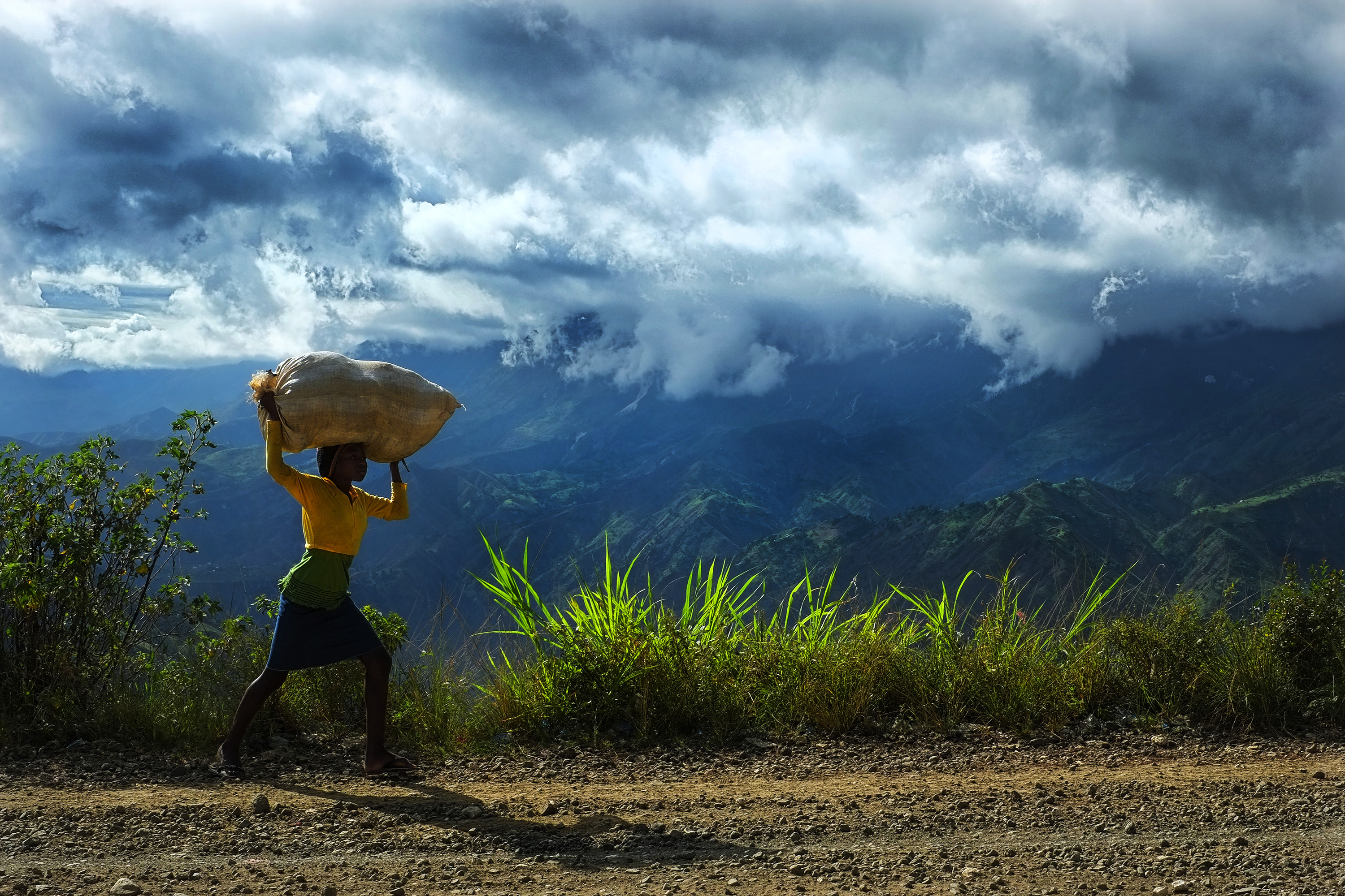Child carrying a bag in Haiti countryside
