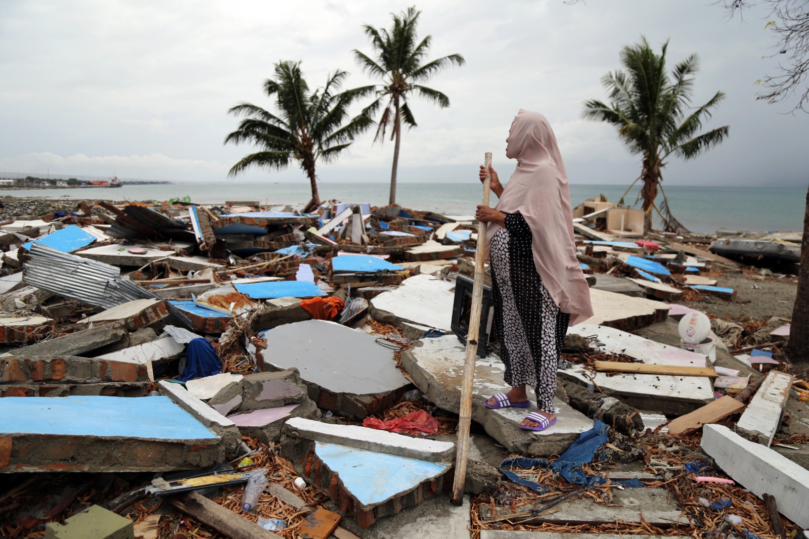 Woman standing in flooded area. Photo Credit: OCHA/Anthony Burke