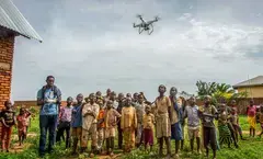 drone flying over a group of people in the Democratic Republic of Congo