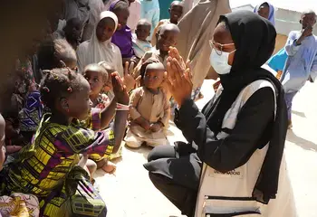Photograph of a humanitarian worker with children